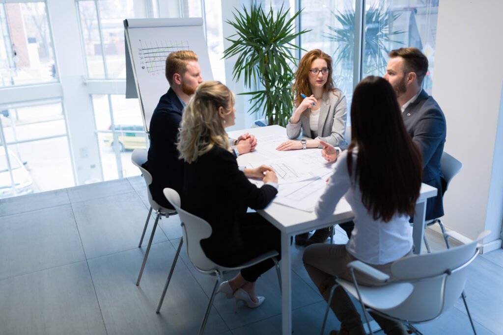 A team of diverse professionals in an office, working with focused productivity.